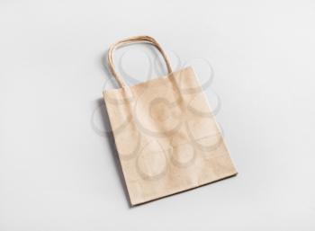Photo of paper shopping bag on paper background. Craft paper package.