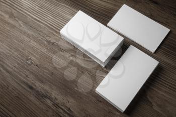 Blank business cards mockup on wooden table background. Corporate stationery set.