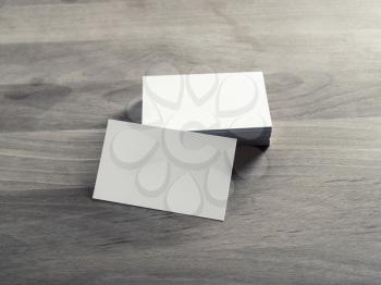 Blank business cards on vintage wooden background. Mockup for branding identity.