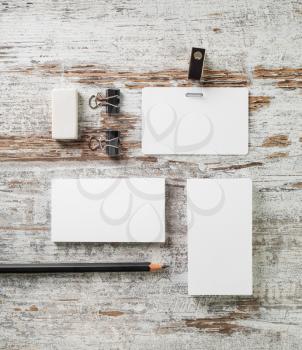 Blank stationery set on wooden background with plenty of copy space. Flat lay.