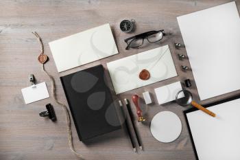 Photo of vintage stationery set on wood table background. Blank ID template. Mock up for branding identity. Flat lay.