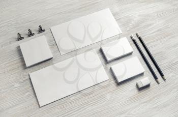Photo of blank stationery set on light wooden background. Corporate identity mock up for placing your design.