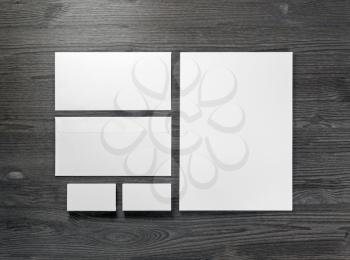 Blank corporate stationery on wood table background. Flat lay. Responsive design mock up.