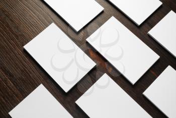 Blank white business cards on wooden background. Mockup for branding identity. Responsive design template.