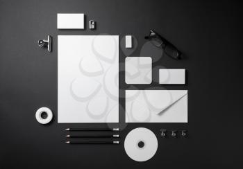 Blank stationery set on black paper background. Template for branding identity. For graphic designers presentations and portfolios. Top view.