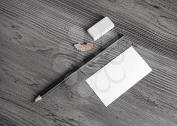 Blank stationery set. Business card, pencil and eraser on wood background. Top view.