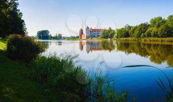Medieval castle on the shore of the lake. Castle in Mir, Belarus - historical heritage of Belarus.