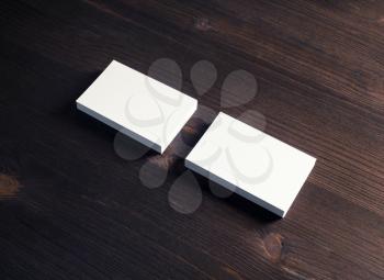 Two blank business cards on wooden background. Template for ID.