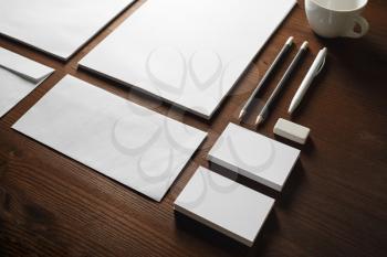 Photo of blank stationery set on wood table background. Corporate identity mock up for placing your design.