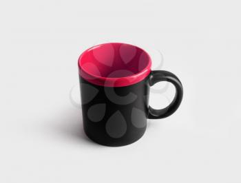 Blank black and red ceramic mug or cup for coffee or tea.