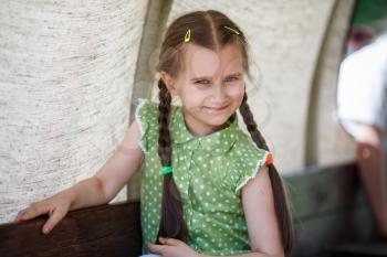 Summer portrait of a smiling little girl. Selective focus.