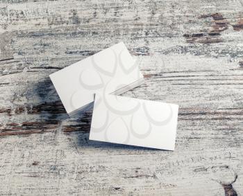 Blank white business cards on vintage wooden background. Template for ID with plenty of copy space.