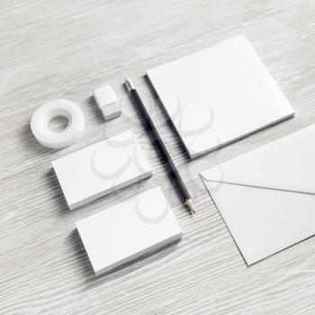 Photo of blank stationery set on light wooden background. Corporate identity mockup. Responsive design template.