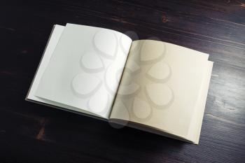 Blank book or brochure on dark wooden background. Copy space for text.