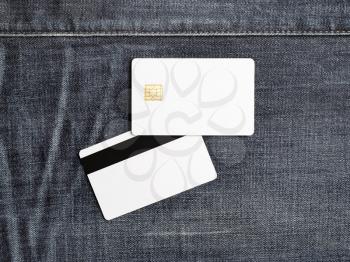 Photo of blank plastic bank cards on denim background. White credit cards. Front and back view. Template for placing your design. Flat lay.