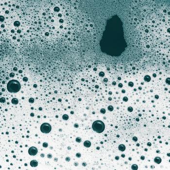 Foam with bubbles. Shampoo or detergent in water. Flat lay.
