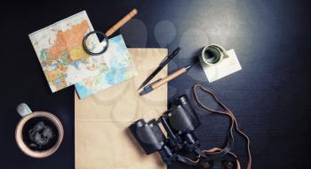 Essential travel accessories on black table background. Making travel plan. Top view. Flat lay.