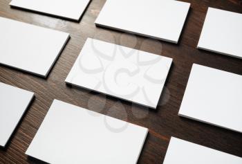 Photo of blank business cards on wood table background. Template for branding identity.