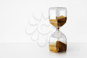 Hourglass on light background with copy space. Time Running Out.