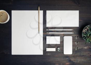 Blank branding identity set on wood table background. Corporate stationery template. Top view. Flat lay.