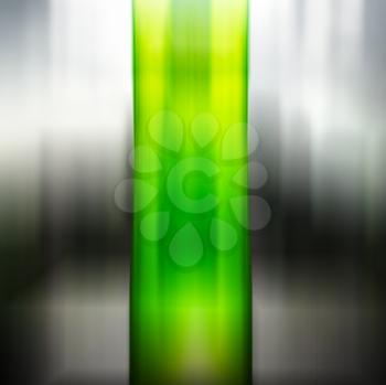 Vertical green motion blurred column on black and white backgroundd