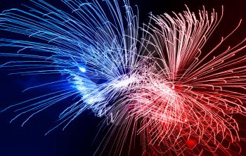 Dramatic red and blue fireworks at night sky background