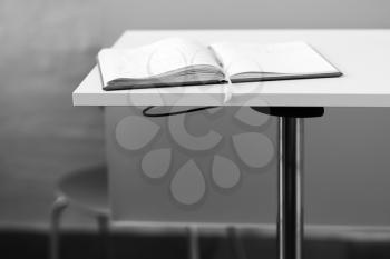 Opened black and white book on table backdrop hd