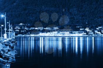 Night Tromso city pier with lamp reflections background hd