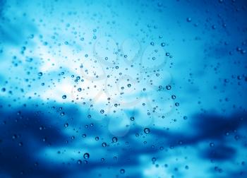 Blue rain drops on window glass background hd