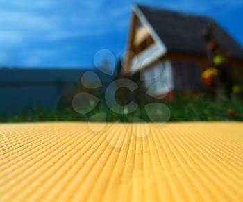 Yellow bedstone texture near country side house background