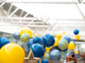 Yellow and blue balloons bokeh background