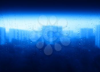 Blue raindrops on window city texture background