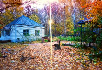 Cabin in autumn park with light lamp background