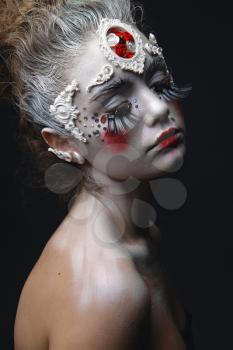 Portrait of a beauty young girl with white hair and original creative makeup.
