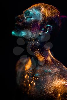 Conceptual shot of light and shine fluorescent  colors young man's face