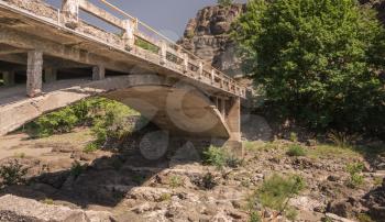 New bridge over the enetikos river with green water and  beautiful rock formations near Meteora in Greece