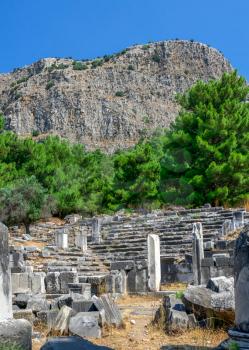 Ruins of the Bouleuterion or council house in the ancient city of Priene, Turkey, on a sunny summer day.