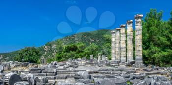 Ruins of the Temple of Athena Polias in the ancient city of Priene, Turkey, on a sunny summer day. Big panoramic shot.