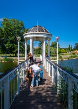 Zaporozhye, Ukraine 07.21.2020. Bridge over the pond and gazebo in Voznesenovsky park in Zaporozhye, Ukraine, on a sunny summer morning