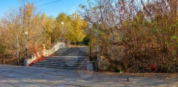 Old staircase in the park near the lake on a sunny autumn evening in the village of Ivanki, Cherkasy region, Ukraine