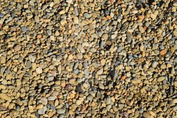 Background from small round crushed stone. A heap from a small pellet.
