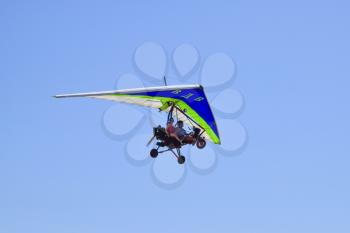 Russia, Veselovka - September 6, 2016: Trike, flying in the sky with two people. Extreme Entertainment travelers