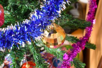 Glass beads for decorating the Christmas tree. Tinsel, balls and toys decorated fir.