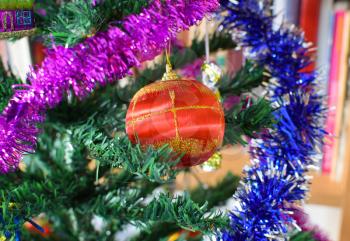 Glass beads for decorating the Christmas tree. Tinsel, balls and toys decorated fir.