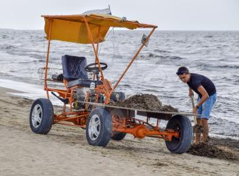 The car for garbage collection from the beach. Cleaning on the beach, clean beach from mud and waste.