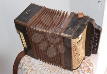 Old dusty accordion. Musical instruments of the Russian village.
