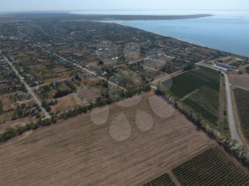 Top view of the small village. Aerophotographing above the village. The village near the sea.