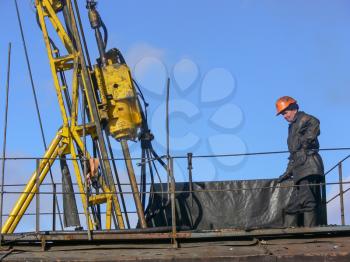 worker checks the equipment on the rig for coring. The trailer with the equipment.