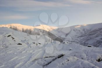 Winter mountain landscape in Yakutia. Snow-covered hills and low mountains.
