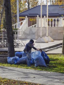 Slavyansk-na-Kubani, Russia - September 9, 2016: The workers of the municipality collect leaves in the park. Women social workers removed the foliage.